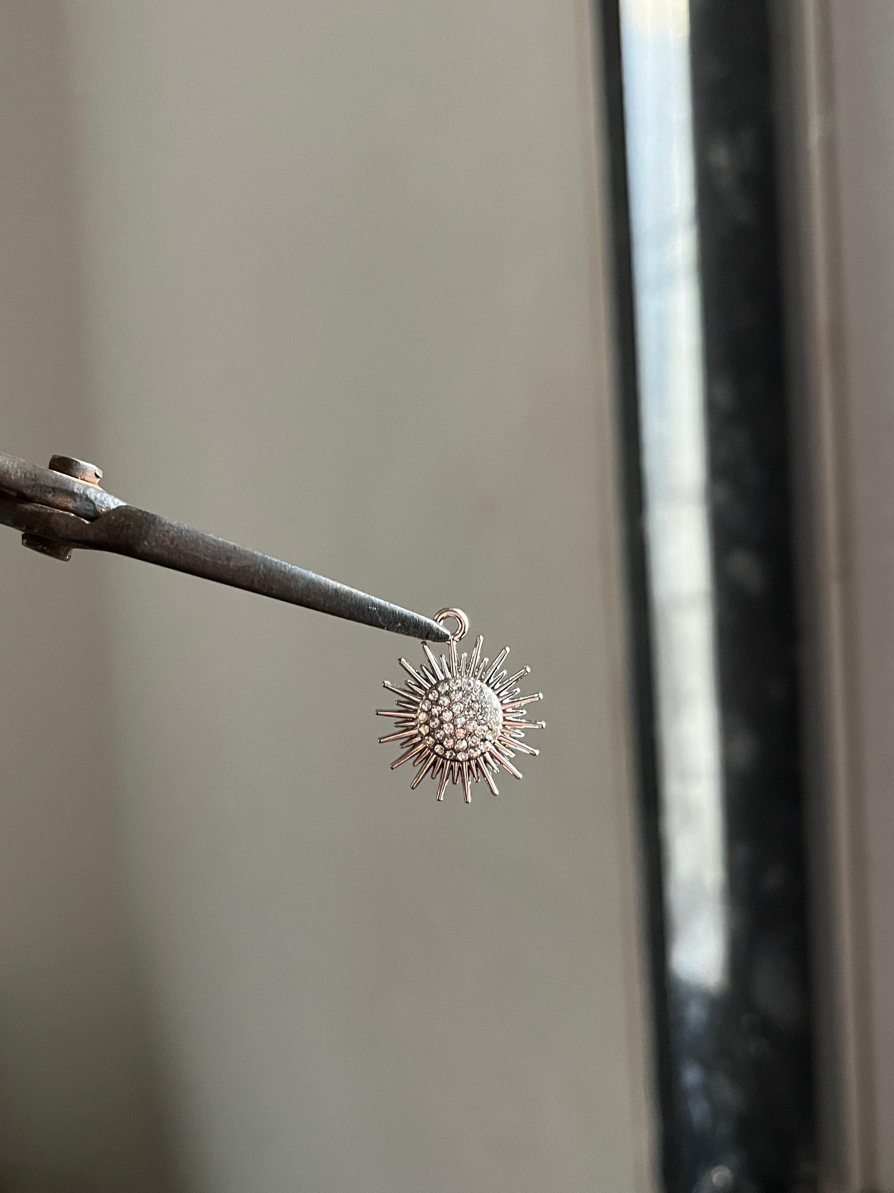 spikey sun charm