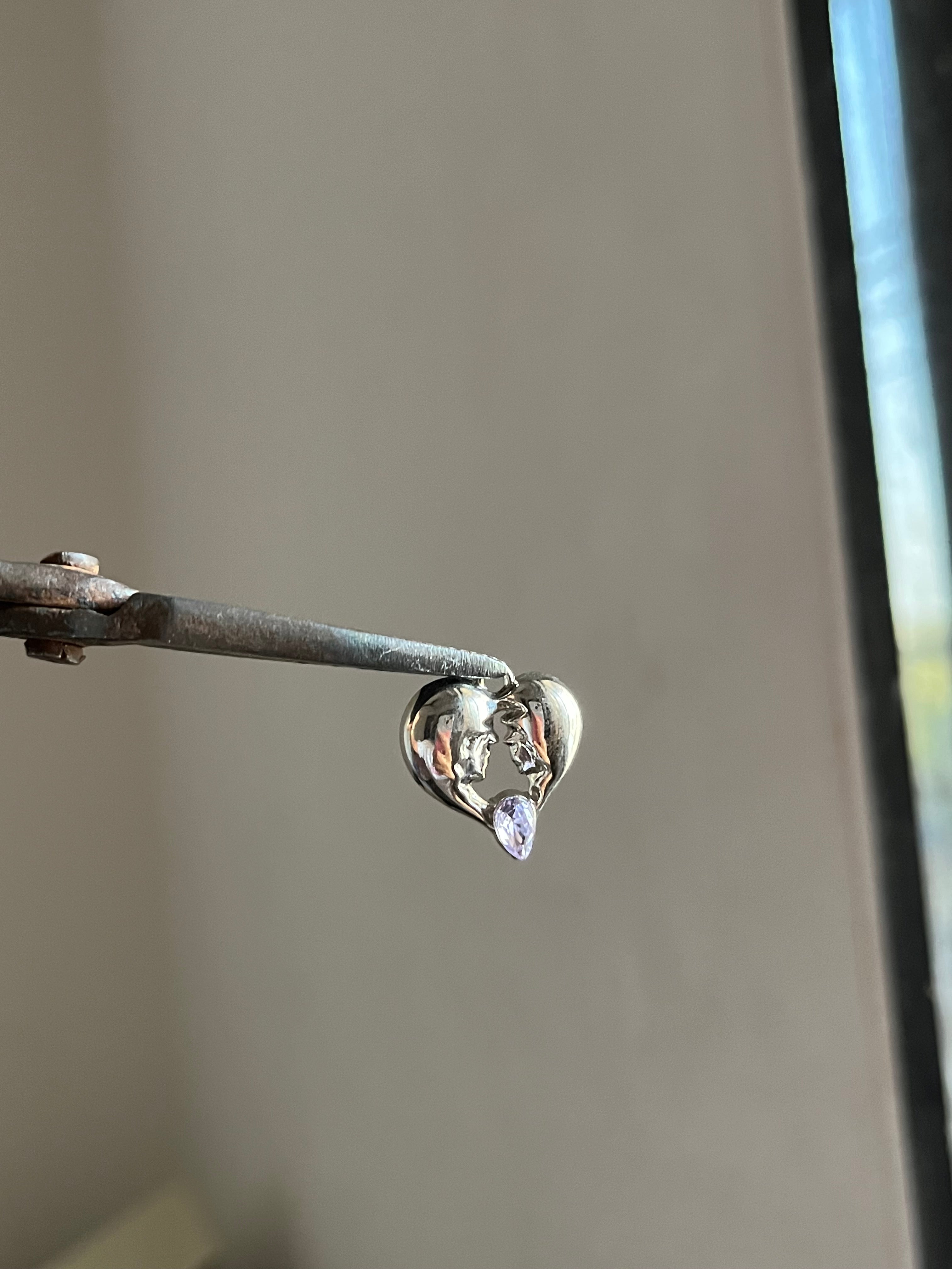 tore heart charm