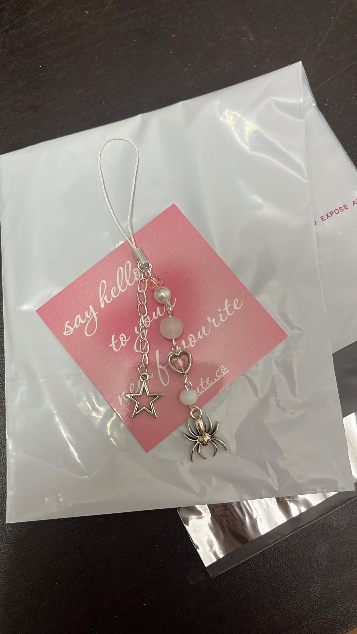white spider phone charm